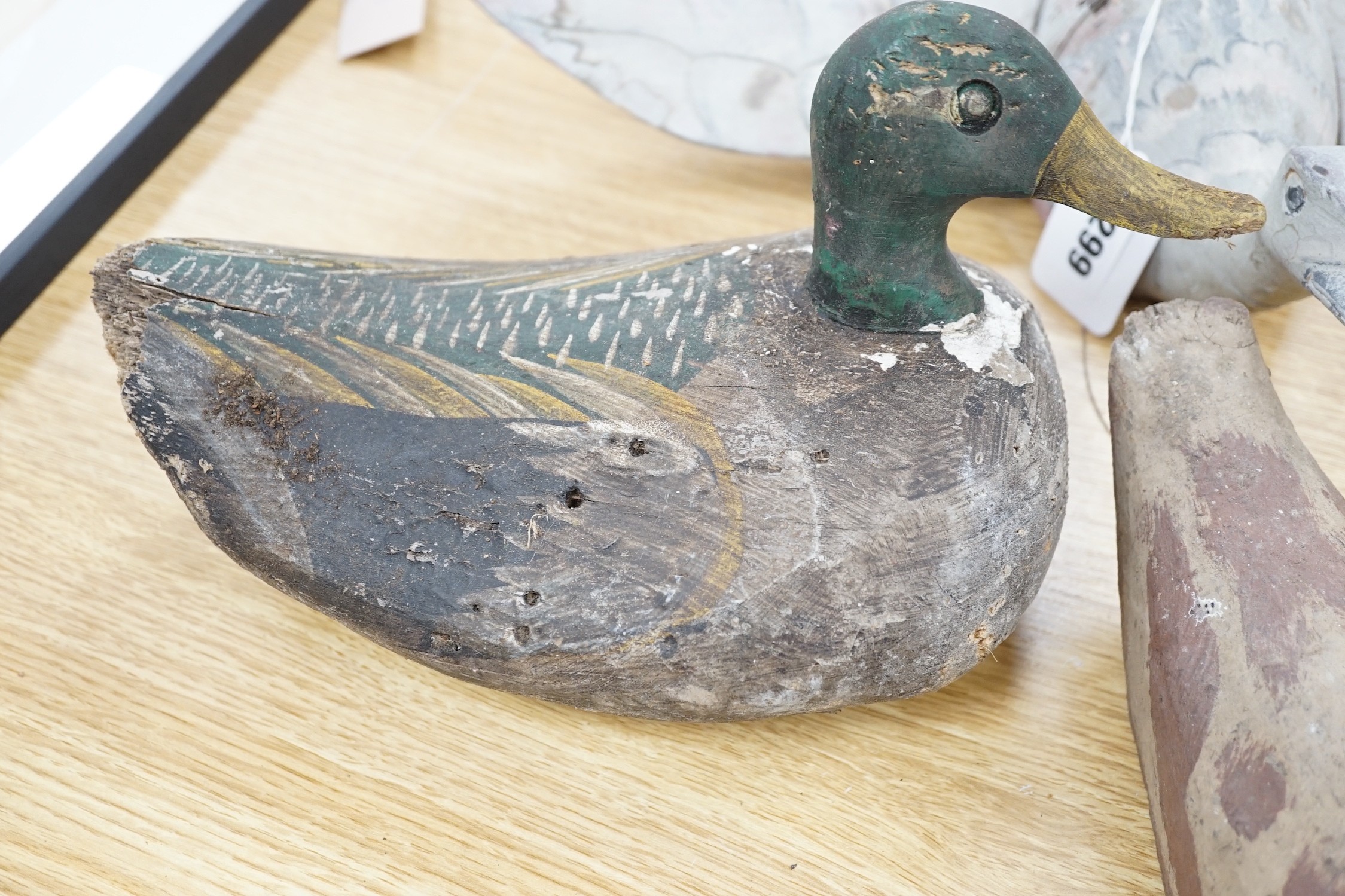 Five primitive wood decoy ducks, one in flight, longest 40cm
